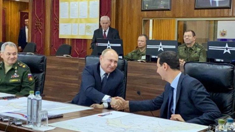 Russian President Vladimir Putin shakes hands with Syria's President Bashar al-Assad in Damascus, Syria in this handout released by SANA on January 7, 2020.