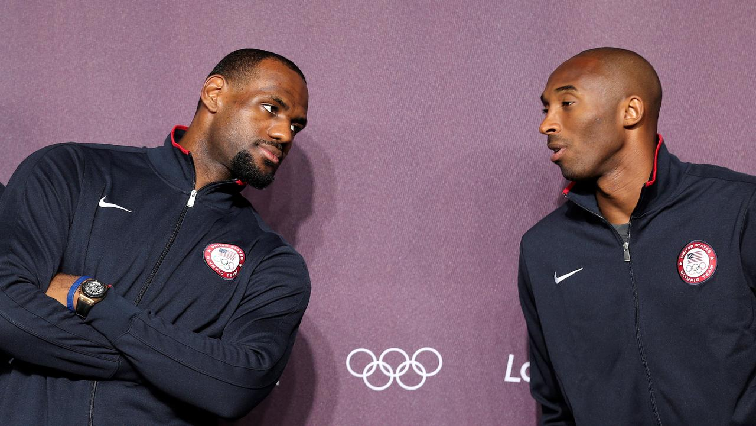 US basketball player Kobe Bryant (R) talks with his teammate LeBron James during a news conference in the Olympic media centre before the start of the London 2012 Olympic Games