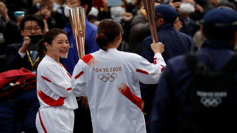 Actress Satomi Ishihara, Official Ambassador of the Tokyo 2020 Torch Relay, receives the olympic torch during a rehearsal as part of the Tokyo 2020 Olympic Torch Relay in Hamura, outskirts of Tokyo