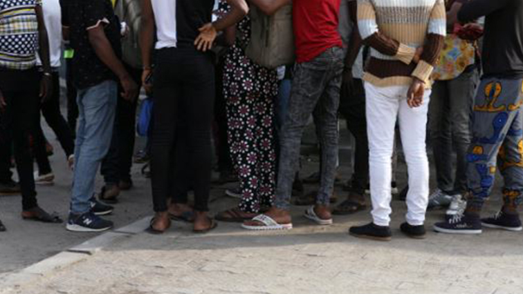 Some of the men charged with public displays of affection with members of the same sex are seen gathered within the premises of the Federal High Court after the court-hearing of their case in Lagos
