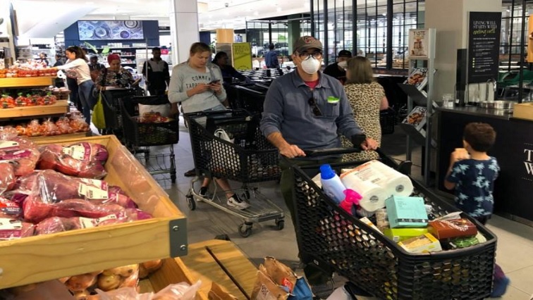 Shoppers queue to stock up on groceries ahead a nationwide lockdown called to limit the spread of coronavirus disease (COVID-19), in Cape Town, South Africa, March 24, 2020.