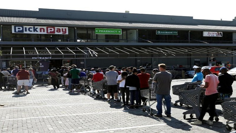 Shoppers queue to stock up on groceries at a Pick n Pay store during a nationwide lockdown of 21 days to try to contain the coronavirus disease (COVID-19) outbreak, in Johannesburg, South Africa, March 24, 2020.
