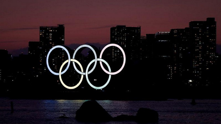The giant Olympic rings are seen in the dusk at the waterfront area at Odaiba Marine Park in Tokyo, Japan, March 22, 2020.