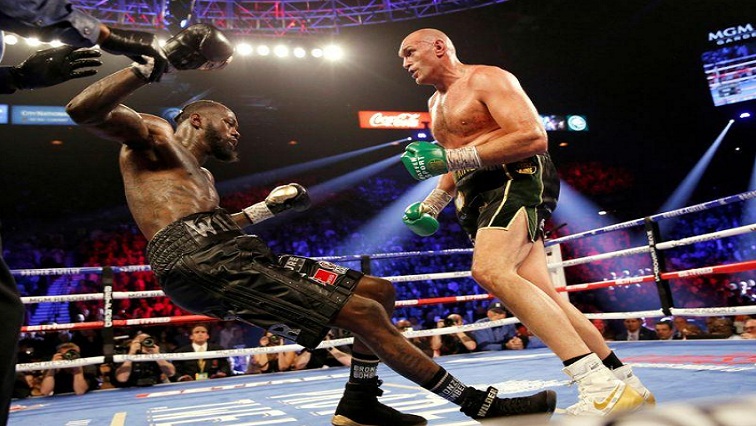 Tyson Fury knocks down Deontay Wilder during the fight.