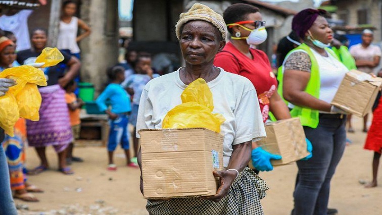 An elderly woman is seen with a food parcel she received from volunteers at a relief distribution, during a lockdown by the authories in efforts to limit the spread of the coronavirus disease (COVID-19), in Lagos, Nigeria April 9, 2020.