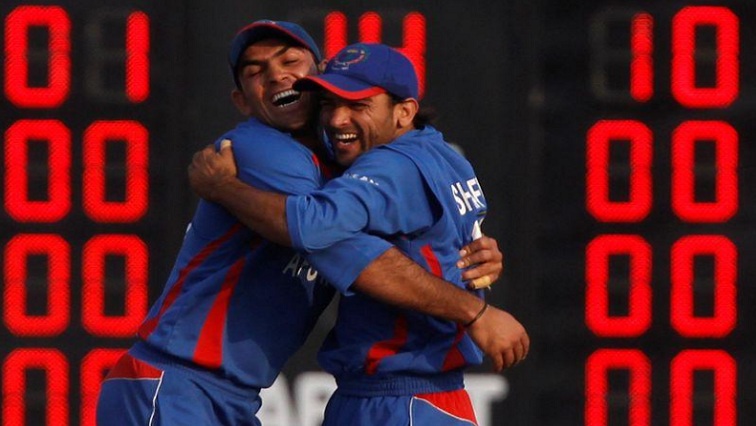 Afghanistan's Samiullah Shinwarai (L) and Shafiqullah Shafaq celebrate the wicket of Bangladesh's Shuvagoto Hom Chowdhury during their gold medal cricket match at the 16th Asian Games in Guangzhou.
