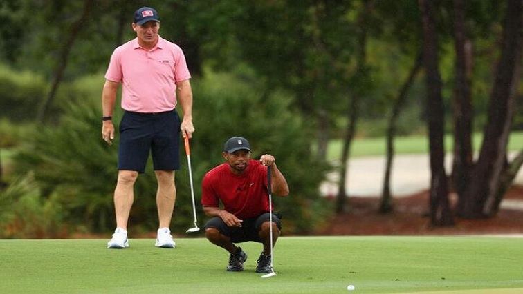Tiger Woods and former NFL player Peyton Manning read a putt on the sixth green during The Match: Champions for Charity golf round at the Medalist Golf Club.