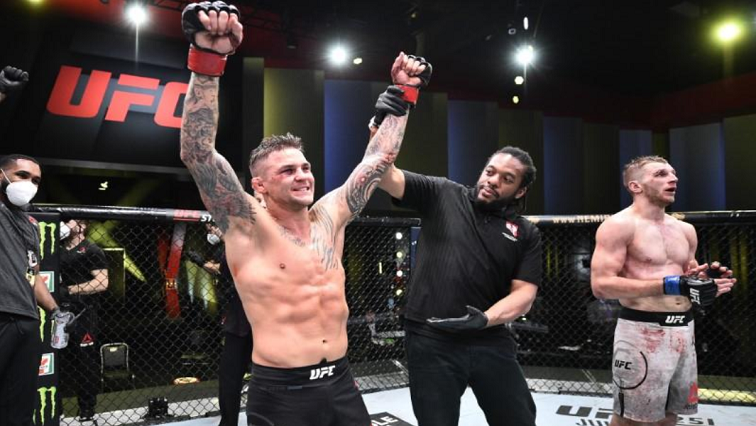 Dustin Poirier (red gloves) celebrates after defeating Dan Hooker of New Zealand (blue gloves) during UFC Fight Night at the UFC APEX.