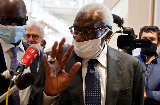 Former President of the International Association of Athletics Federations (IAAF) Lamine Diack, wearing a face mask, gestures as he arrives for his trial at the Paris courthouse, France, June 8, 2020.