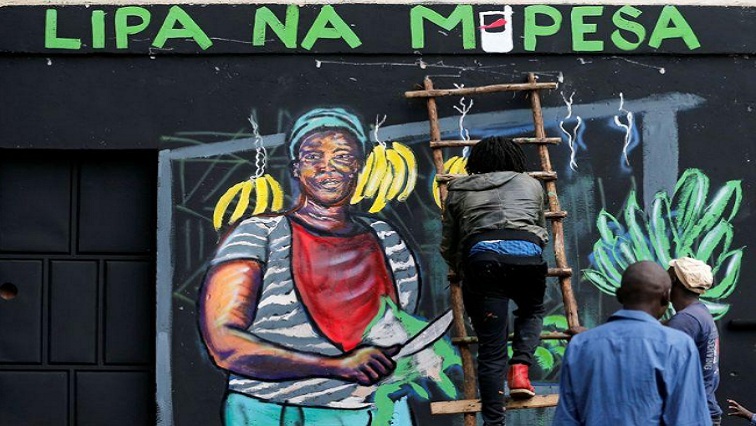 An artist works on a mural advocating for retail M-Pesa mobile phone cashless payments as a measure against the spread of the coronavirus disease (COVID-19) in Nairobi, Kenya April 19, 2020.