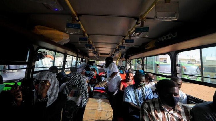 A health worker checks the temperature of teachers as they sit in a government chartered bus bringing people back to schools of countryside towns, which are scheduled to reopen next week, amid travel bans between regions due to the coronavirus disease (COVID-19) outbreak, in Dakar, Senegal May 28, 2020.