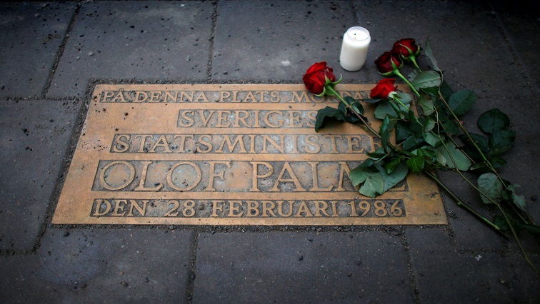 FILE PHOTO: Roses are laid on a plaque marking the location where Swedish Prime Minister Olof Palme was shot and killed 25 years ago on a street in Stockholm February 28, 2011.