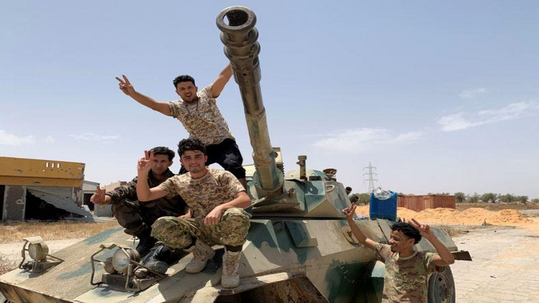 Fighters loyal to Libya's internationally recognised government celebrate after regaining control over the city, in Tripoli, Libya, June 4, 2020.