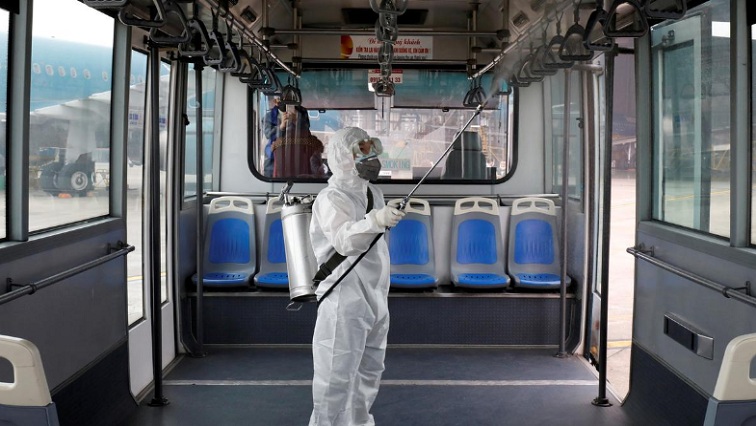A health worker sprays disinfectant inside a bus to protect from the recent coronavirus outbreak, at Noi Bai airport in Hanoi, Vietnam.