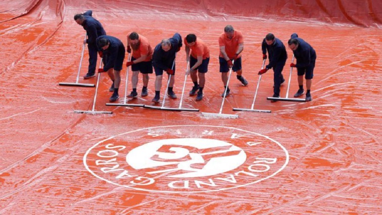 Grounds staff clean the court during Serbia's Novak Djokovic and Austria's Dominic Thiem semifinal match.