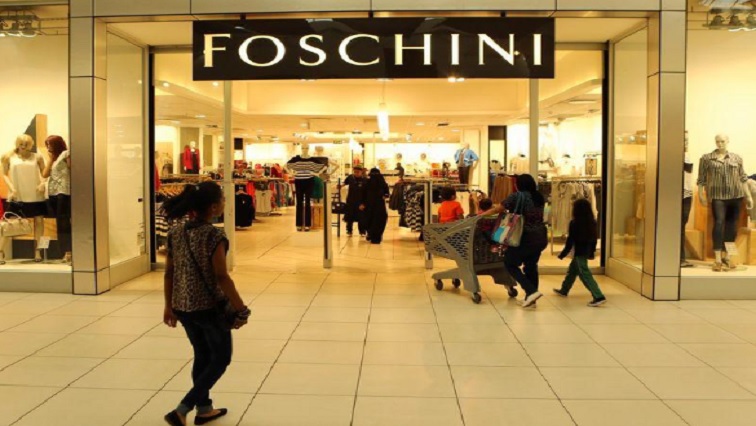 A shopper walks past a Foschini store at a shopping centre in Lenasia, south of Johannesburg.