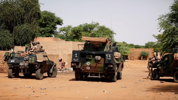 FILE PHOTO: French soldiers patrol in the streets of Gossi, Mali.