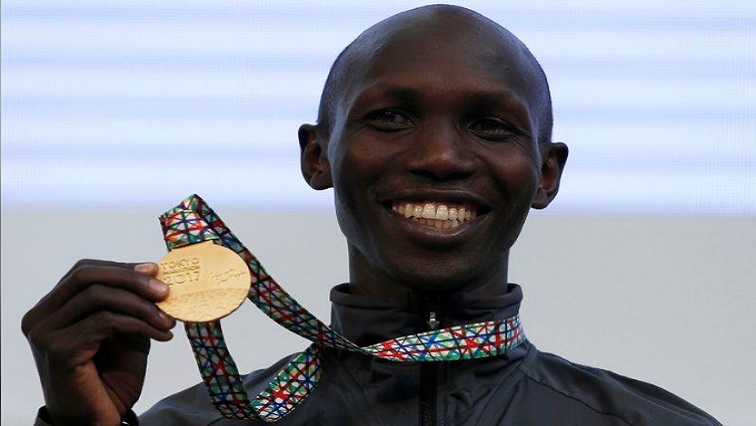 Gold medalist Wilson Kipsang of Kenya poses on podium.