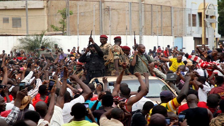 A crowd of people cheer Malian army soldiers at the Independence Square after a mutiny, in Bamako, Mali, on August 18, 2020.
