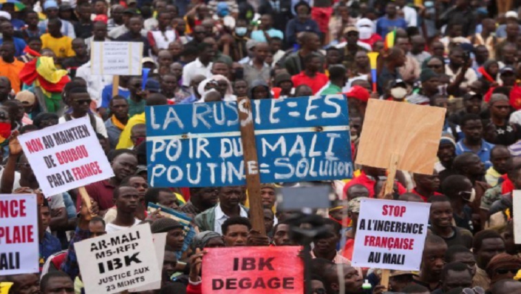 Supporters of the Imam Mahmoud Dicko and other opposition political parties attend a mass protest demanding the resignation of Mali's President Ibrahim Boubacar Keita in Bamako, Mali on August 11, 2020. The blue sign reads: "Russia is the hope for Mali, Putin=Solution".