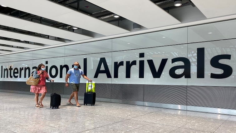 FILE PHOTO: Passengers from international flights arrive at Heathrow Airport, following the outbreak of the coronavirus disease (COVID-19), London.