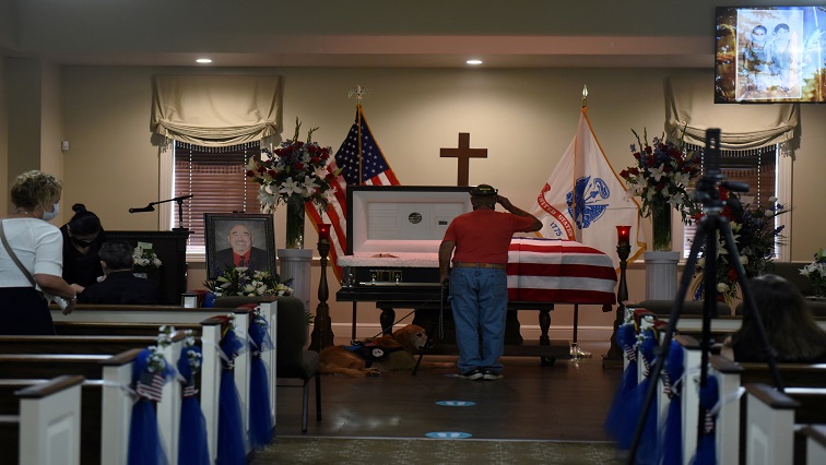 A veteran salutes the casket of David Gutierrez who died of coronavirus disease (COVID-19) in Houston, Texas.