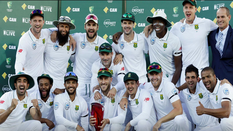 FILE PHOTO: South Africa's captain Faf du Plessis (C) holds the Test series trophy against Australia with team mates at the end of the Third Test cricket match. At right is former South African cricketer Kepler Wessels who presented du Plessis with the trophy.