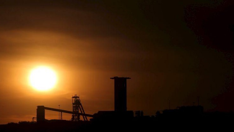 The sun sets behind a shaft outside the mining town of Carletonville, west of Johannesburg.