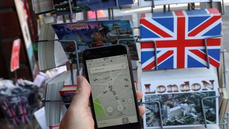A photo illustration shows the Uber app and London themed postcards in London, Britain June 26, 2018.