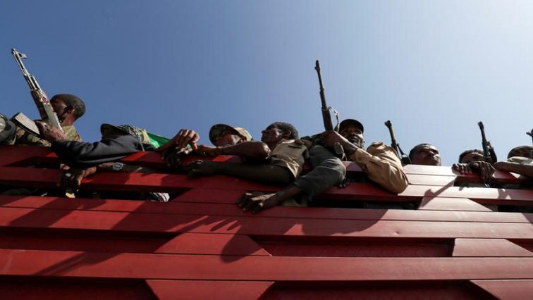 Members of Amhara region militias ride on their truck as they head to the mission to face the Tigray People's Liberation Front (TPLF), in Sanja, Amhara region near a border with Tigray, Ethiopia November 9, 2020.