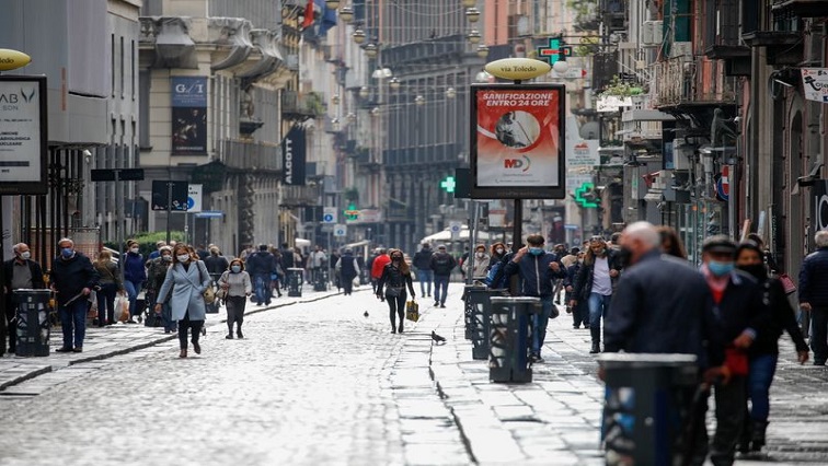 People walk at a street a year after the peak of Italy's coronavirus disease (COVID-19) outbreak, in Bergamo, the country's epicentre.