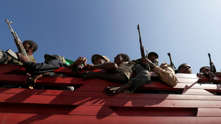 Members of Amhara region militias ride on their truck as they head to the mission to face the Tigray People's Liberation Front (TPLF), in Sanja, Amhara region near a border with Tigray, Ethiopia.