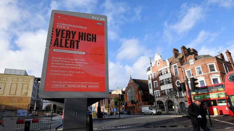Pedestrians walk past a British government health information advertisement highlighting new restrictions amid the spread of the coronavirus disease (COVID-19), London, Britain, on December 19, 2020.