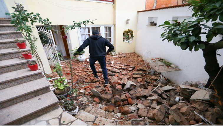 A man walks over debris after an earthquake, in Zagreb, Croatia, on December 29, 2020.