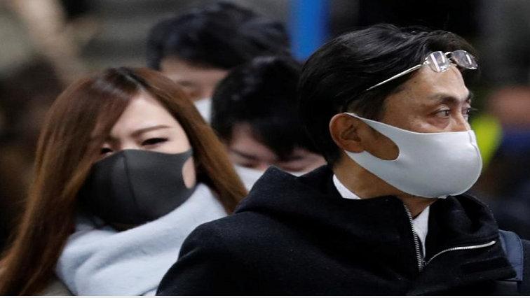 Pedestrians wearing protective masks, following the coronavirus disease (COVID-19) outbreak, walk out of a station during a commuting hour at a business district in Tokyo, Japan, on January 7, 2021.
