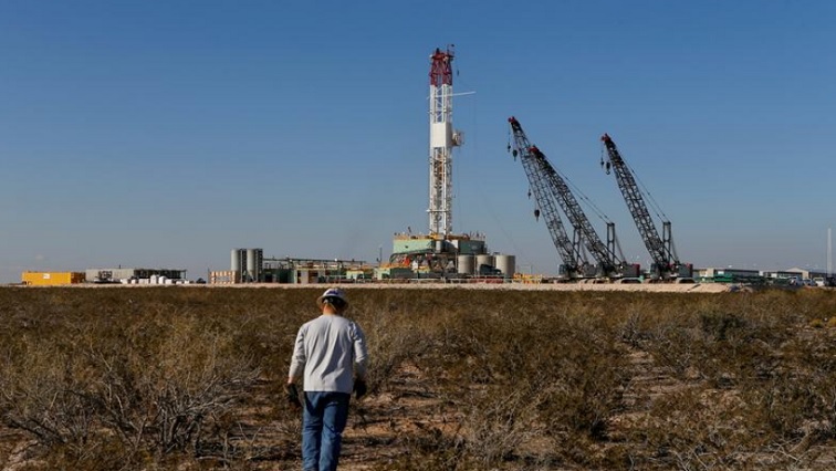 An oil worker walks toward a drill rig after placing ground monitoring equipment in the vicinity of the underground horizontal drill in Loving County, Texas, U.S., November 22, 2019.