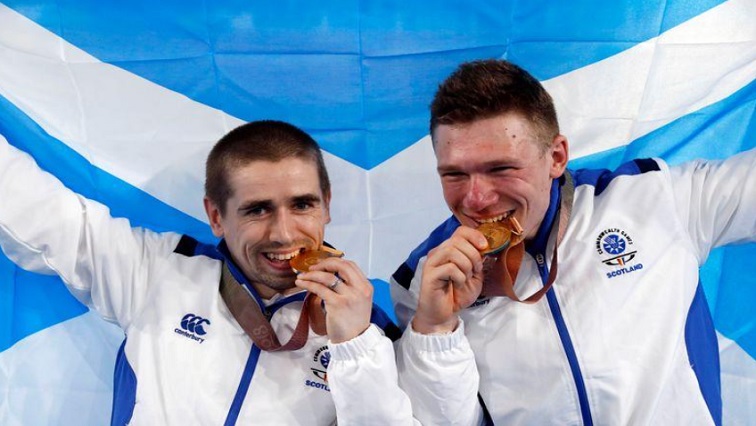Neil Fachie and pilot Matt Rotherham of Scotland celebrate winning a gold medal.