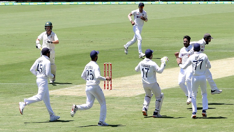 Shardul Thakur of India celebrates with team mates after getting the wicket of Marcus Harris of Australia during day one of the fourth test match