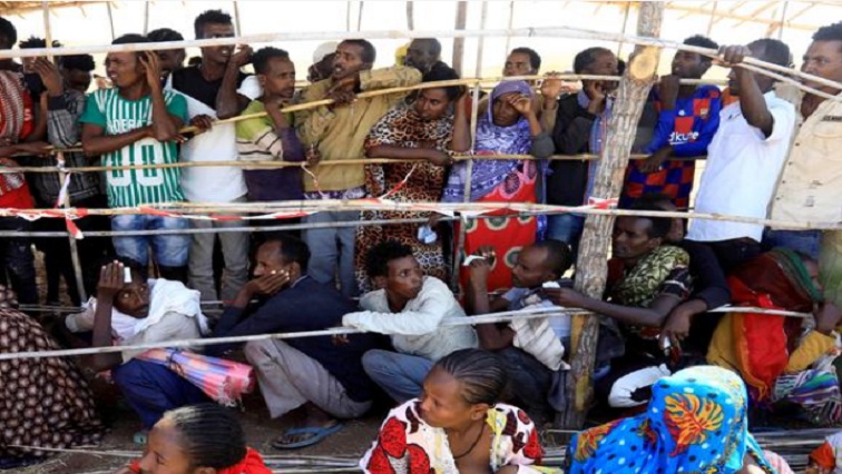 FILE PHOTO: Ethiopians who fled the ongoing fighting in Tigray region gather to receive relief aid at the Um-Rakoba camp on the Sudan-Ethiopia border, in Kassala state.