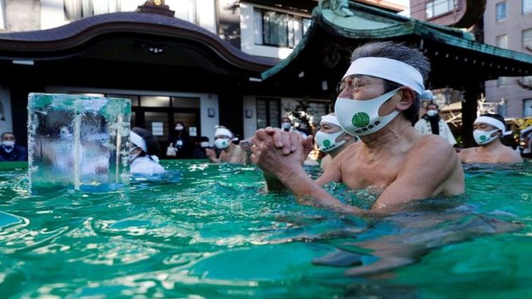 Only a dozen people took part in the annual event at Teppou-zu Inari Shrine, scaled down this year due to the health crisis, compared to over a hundred in early 2020.