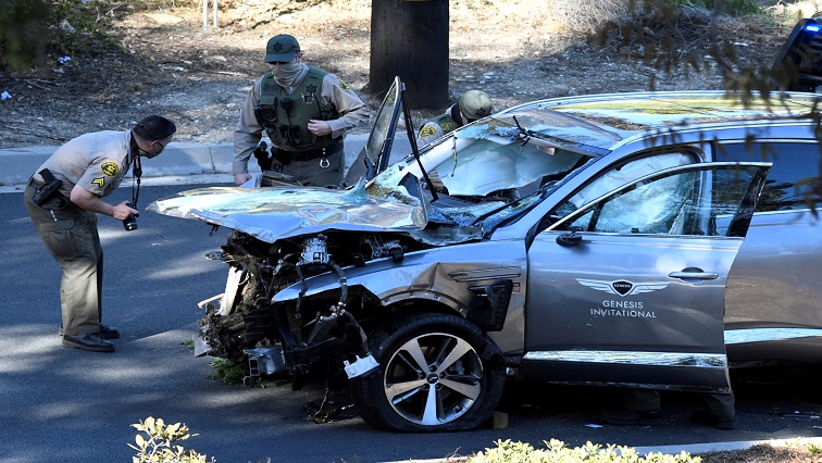 Los Angeles County Sheriff's Deputies inspect the vehicle of golfer Tiger Woods, after it was involved in a single-vehicle accident in Los Angeles, California.