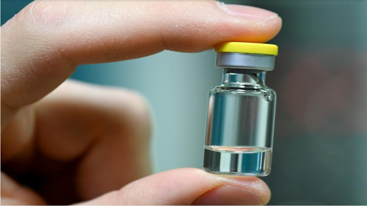A worker of German vaccine maker IDT Biologika shows a sample ampoule during the visit of German Health Minister Jens Spahn in Dessau Rosslau, Germany.