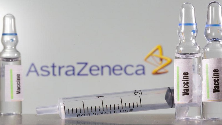 A test tube labelled with the vaccine is seen in front of AstraZeneca logo in this illustration taken, September 9, 2020.