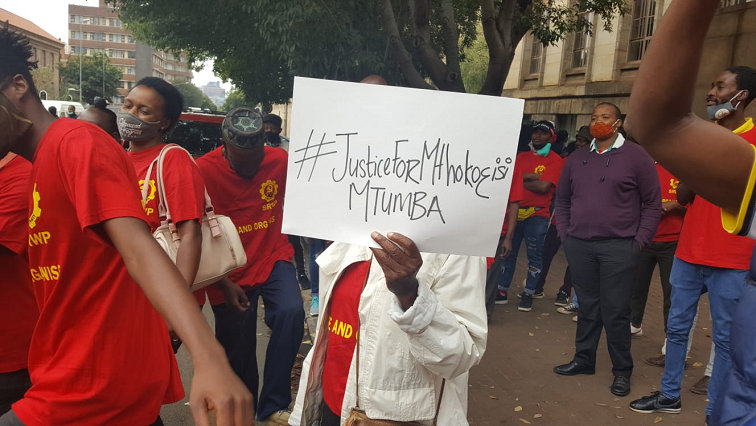 A handful of students gathered outside the Johannesburg Magistrate's Court where four police officers appeared in connection with the fatal shooting of Ntumba.