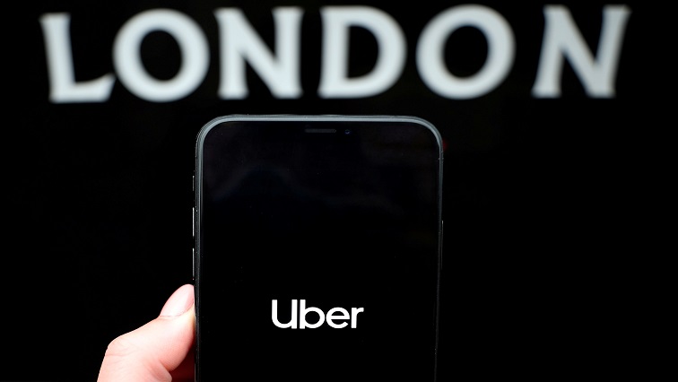 The Uber logo is displayed on a mobile phone {File image]