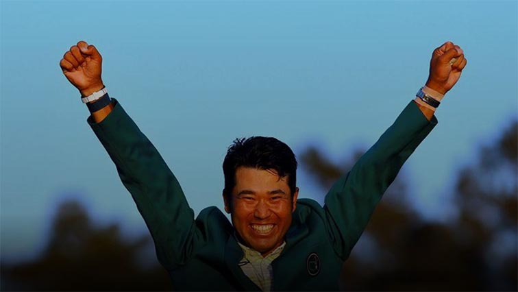 Japan's Hideki Matsuyama celebrates with his green jacket after winning The Masters