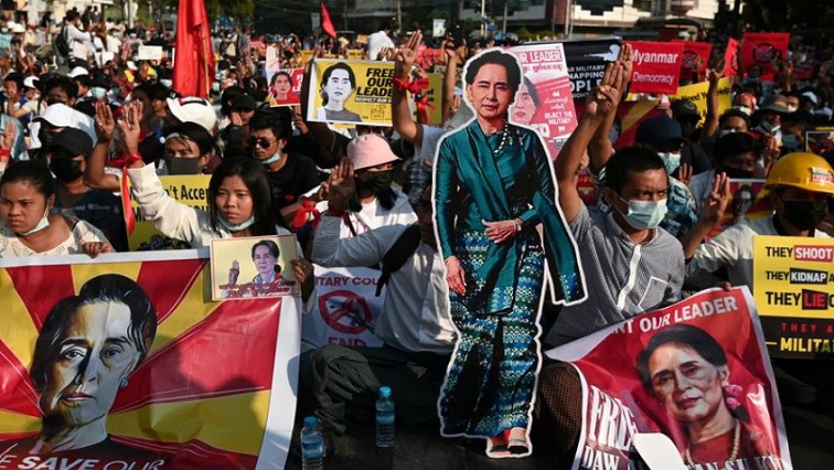 Demonstrators hold placards with the image of Aung San Suu Kyi during a protest against the military coup in Yangon, Myanmar