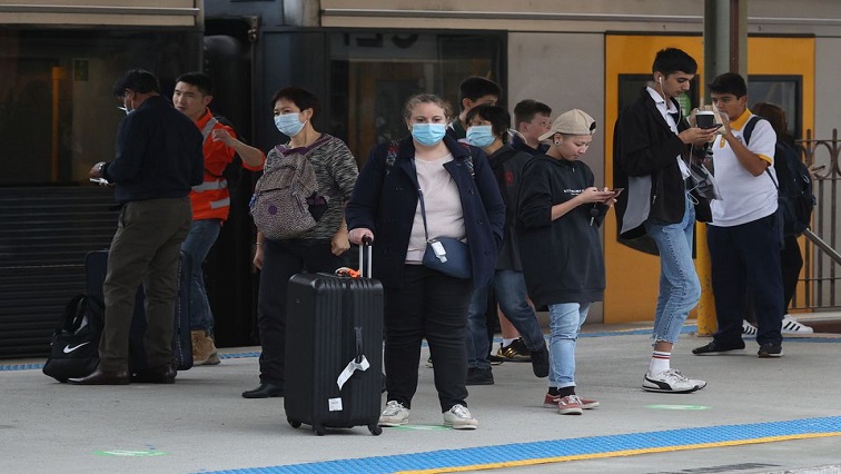 People, some wearing protective face masks, stand on a train platform at Central Station after new public health regulations were announced for greater Sydney, including compulsory mask-wearing on public transport, following the emergence of new cases of the coronavirus disease (COVID-19) in Sydney, Australia, May 6, 2021.