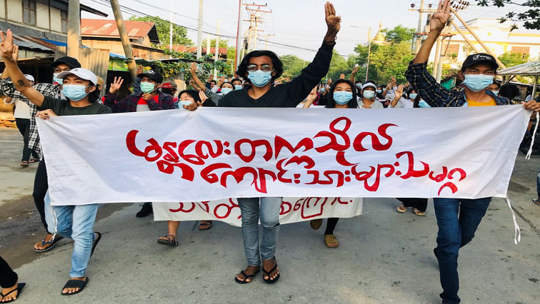 Students hold a banner and flash the three-finger salute as they take part in a protest against Myanmar’s junta, in Mandalay, Myanmar May 10, 2021.