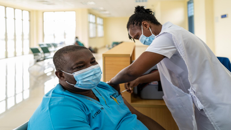 A Malawi healthcare worker gives a vaccine to a patient.